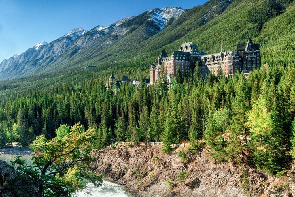 A beautiful treeline shot of Fairmont banff springs with a mountain backdrop.