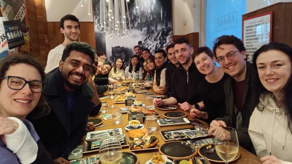 a group of kpler team members sitting at a dinner table eating