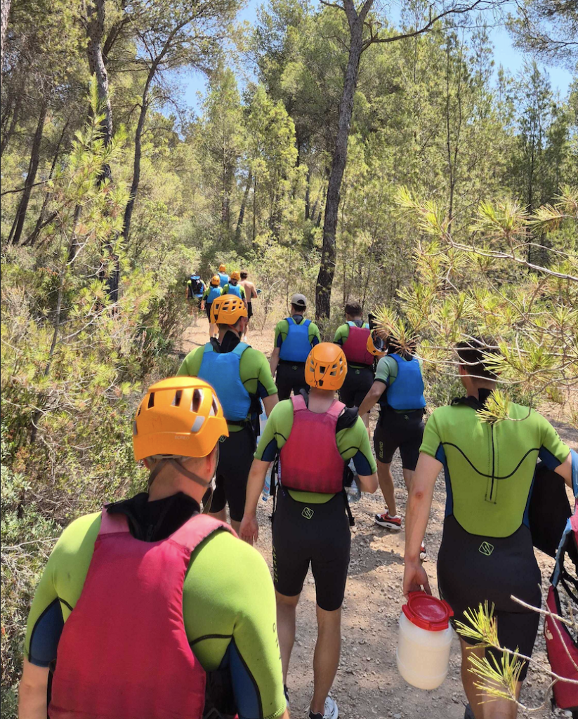 sendcloud team in wet suits walking down a dirt path to go white water rafting